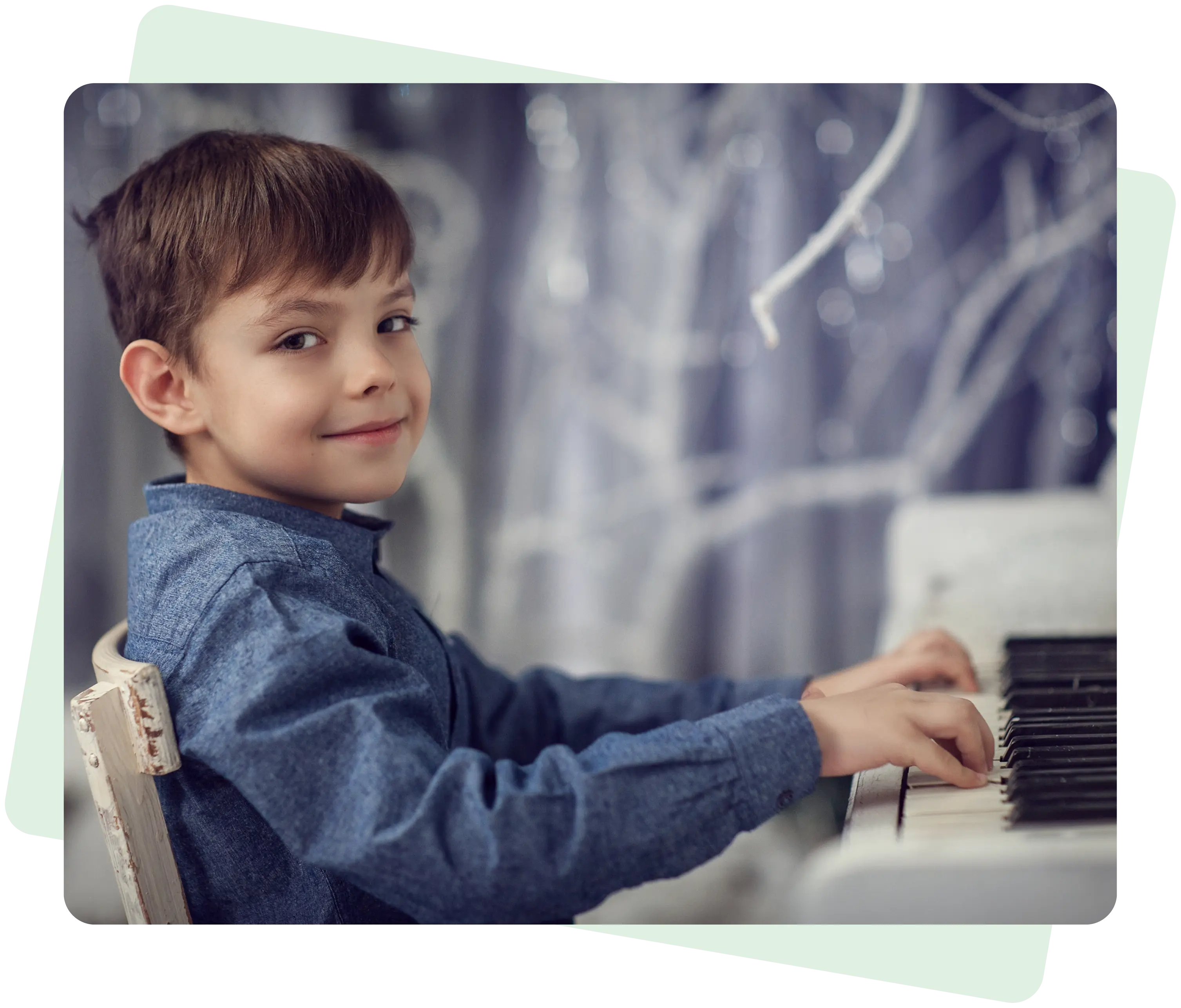 Boy playing piano with a smile.